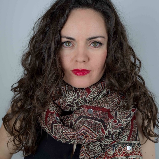 Ainhoa Barrio with red lips and a patterned scarf