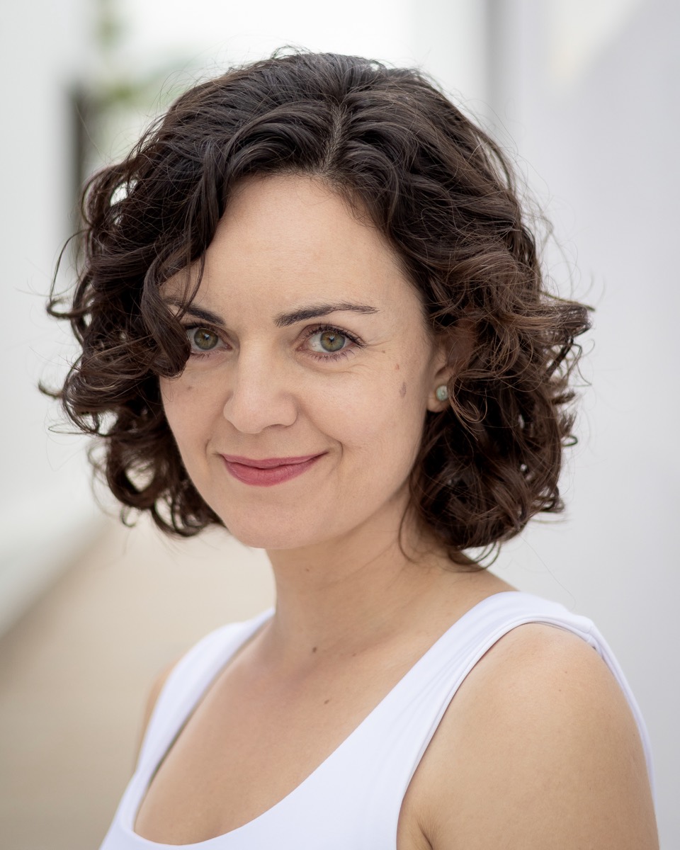 Headshot of Ainhoa Barrio smiling, white top