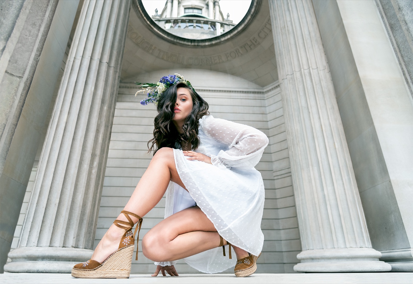 Fashion portrait between stone columns